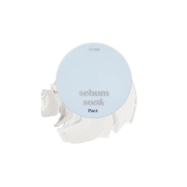 Un compact rond bleu clair avec l'inscription "sebum soak Pact" sur le couvercle