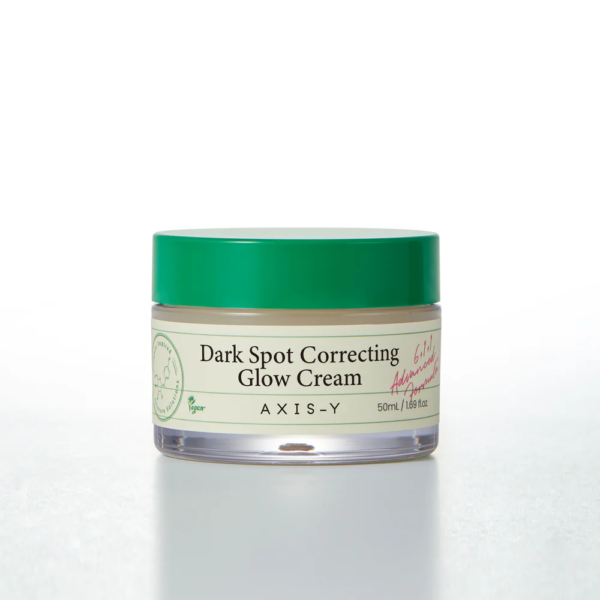 Un pot de Axis Y Dark Spot Correcting Glow Cream Corrige Taches Foncées 50 ml avec un couvercle vert est présenté sur un fond blanc uni.