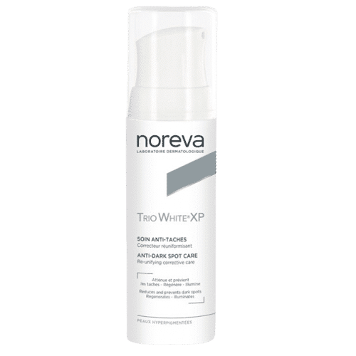 Un flacon de Noreva Trio White XP Soin Anti-Taches 30 ml avec un packaging blanc et un bouchon transparent