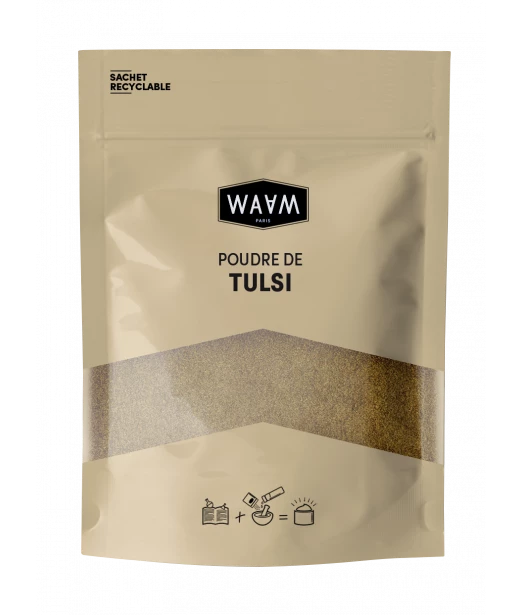 Pochette beige de WAAM Poudre de Tulsi BIO 100g avec une partie transparente dévoilant le produit à l'intérieur. L'emballage comporte des instructions et des informations sur le recyclage. Dakar