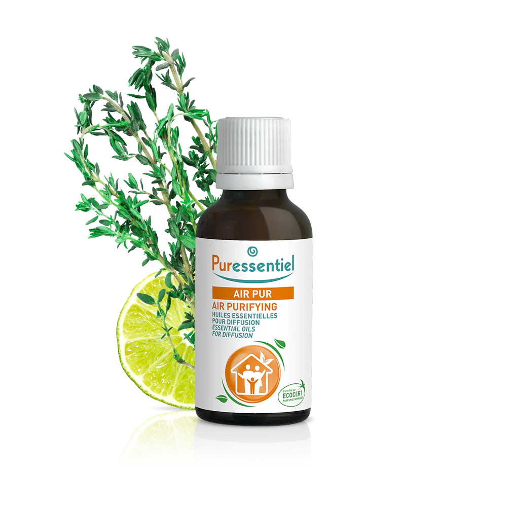 Puressentiel Huile Essentielle Menthe Poivrée BIO Flacon de 30 ml (Copie) avec tranche de citron vert et feuillage en fond.