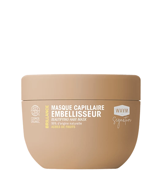 Pot beige étiqueté "Masque capillaire embellisseur" avec un couvercle rond et les détails du produit en texte blanc