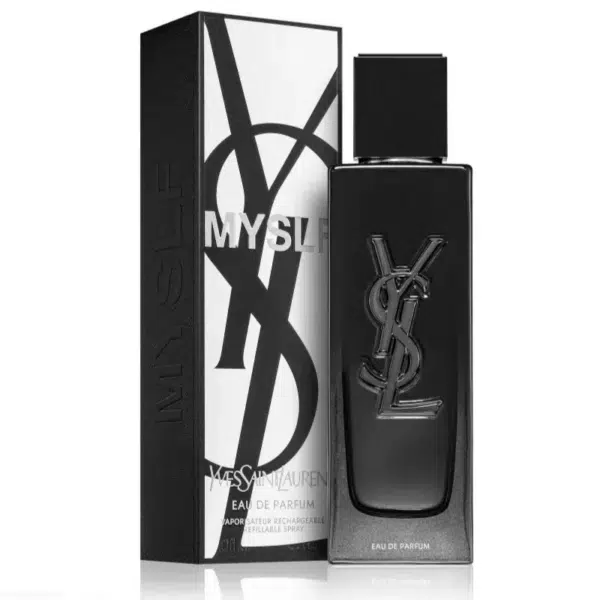 Un élégant flacon de parfum noir, élégamment gravé du logo « YSL », est présenté à côté de sa boîte noire assortie sur laquelle figure le texte « MYSLF Eau de Parfum pour homme ». L'emballage met également en valeur le nom « Yves Saint Laurent », reflétant l'élégance et la sophistication. Dakar