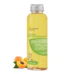 Un flacon transparent de Fleurance Nature Mincifine Huile Raffermissante 100 ml avec une étiquette jaune, mettant en valeur des ingrédients biologiques comme les huiles essentielles de café, de genièvre et de pamplemousse. Deux abricots sont positionnés à côté du flacon. Dakar