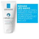 Image d'un tube de La Roche Posay Cicaplast Mains Crème Mains Réparatrice 100 ml sur fond blanc. Le texte bleu à côté du tube se lit comme suit : « Réparez les mains sur-sollicitées, abîmées par les agressions domestiques et professionnelles ». Idéal pour rajeunir les mains surmenées. Dakar